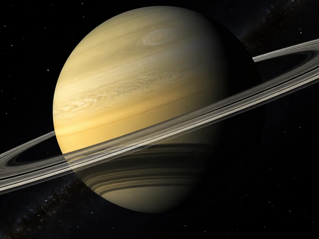 Saturnus i rymden med sina karaktäristiska ringar av is och sten mot en stjärnbeströdd bakgrund